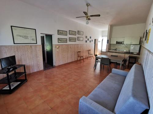 a living room with a couch and a table at Villa Tessitore in LMP