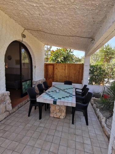 a patio with a table and chairs on a patio at Villa Tessitore in LMP