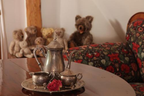 a table with two cups and a tea pot and teddy bears at Hotel und Gasthof Ritter St. Georg in Erlangen