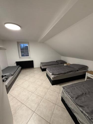 three beds in a room with a ceiling at Levné a dostupné ubytovaní in Teplice