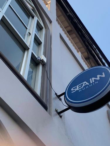 a blue sign on the side of a building at Sea Inn Hua Hin 55 in Hua Hin