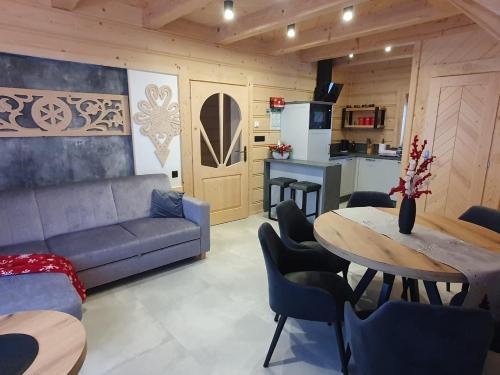 a living room with a couch and a table at Osada Bajka in Murzasichle