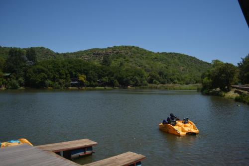 a group of people riding on anlatable raft in a lake at ATKV Klein-Kariba in Bela-Bela