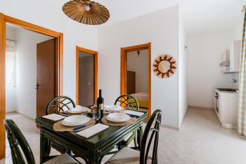 a dining room with a table and chairs at Casa Vacanze Irene - Salento Selection in Torre Lapillo