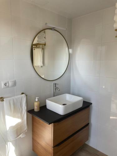 a bathroom with a sink and a mirror at El Portalet in Montblanc