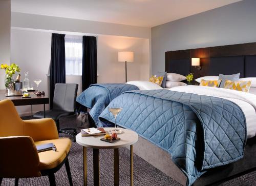 a hotel room with a bed and a desk and chairs at Temple Bar Hotel in Dublin