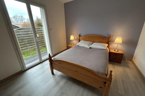 a bedroom with a bed and a large window at Beautiful 2-bedroom family home in Lanton