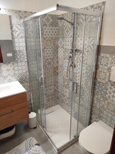 a shower stall in a bathroom with a toilet at Orizzonte Blu Holiday Home in Scalea