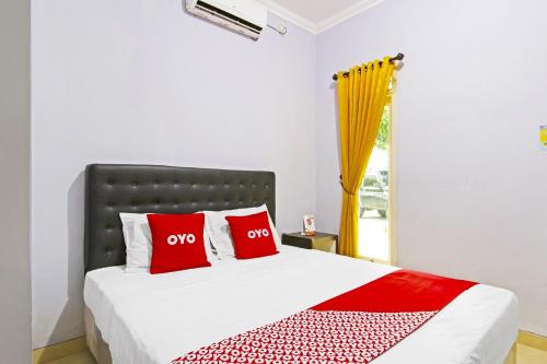 Кровать или кровати в номере Hotel O Homestay Al Maidah