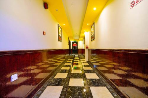 a hallway with a checkered floor in a building at OYO 124 Al Salam Palace Hotel in Manama
