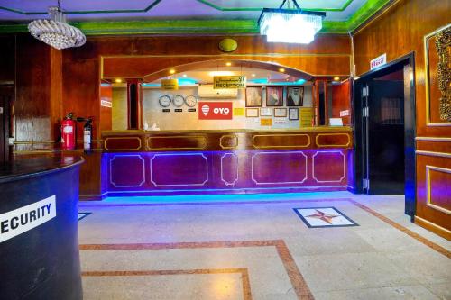 a bar with purple seats in a room at OYO 124 Al Salam Palace Hotel in Manama