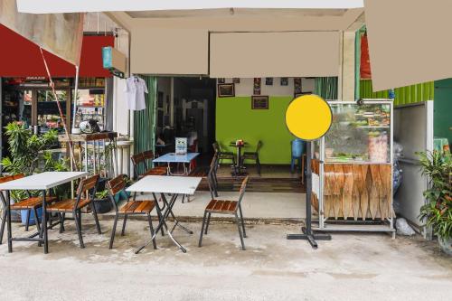 a group of tables and chairs outside of a restaurant at Hotel O Wr House Syariah BatamNearEast Coast Park in Jodoh