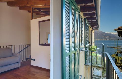 a room with a balcony with a view of the water at Casa Giada in Varenna