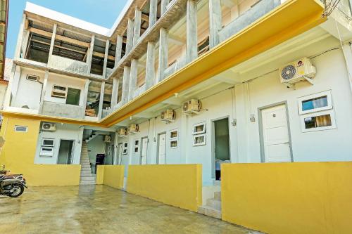 an empty building with a motorcycle parked next to it at OYO 91434 Cek@n Guest House in Banda Aceh