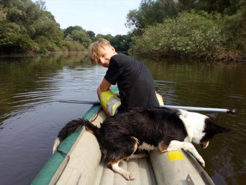 a boy and a dog on a boat in the water at Maringotka Matylda in Libčeves
