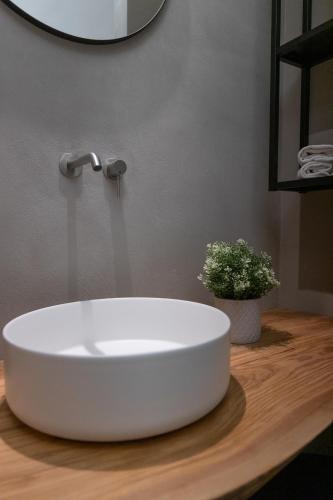 a white sink on a wooden counter in a bathroom at Bed and Breakfast Welcome in Noto