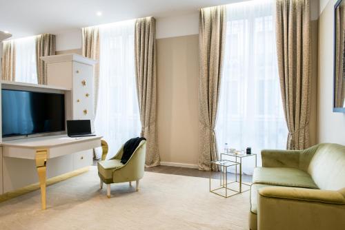 a living room with a desk and a couch at Boscolo Lyon Hotel & Spa in Lyon