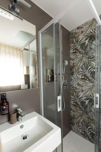 a bathroom with a sink and a shower at Sunset Room&Breakfast in Grado