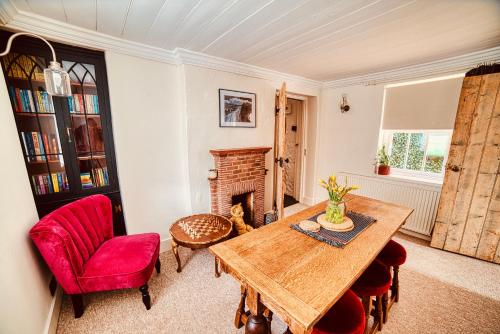 a living room with a table and a fireplace at Beautiful Old Cottage near the Seafront in Eastbourne