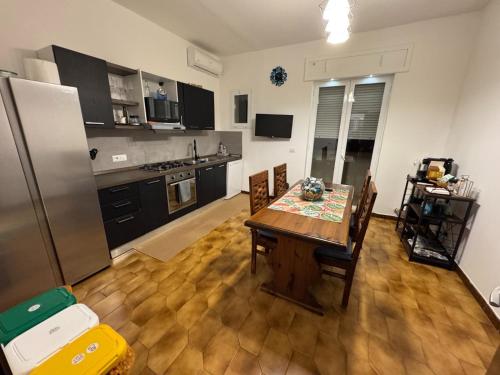 a kitchen with a wooden table and a refrigerator at fuerte in Campi Salentina