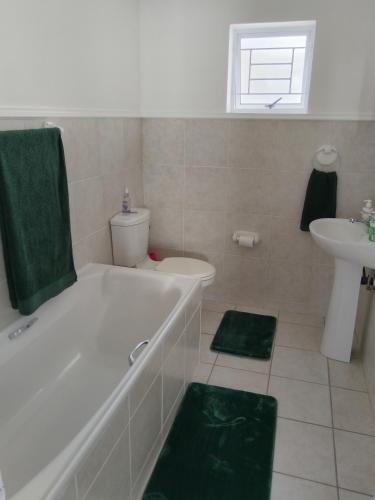 a bathroom with a tub and a toilet and a sink at Cosy Haven Retreat in Sedgefield