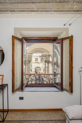 an open window in a room with a balcony at UNYCA - La Loggia Suite in Florence