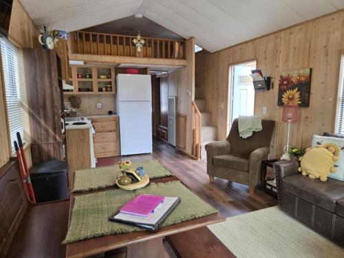 a kitchen and living room in a tiny house at Cabin 9 - Toronto Lake- Fishing, Swimming & More! cabin in Toronto