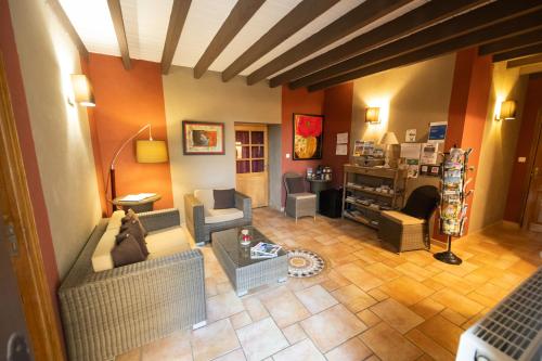 a living room with two couches and a table at Le Moulin de Beaunette in Grane