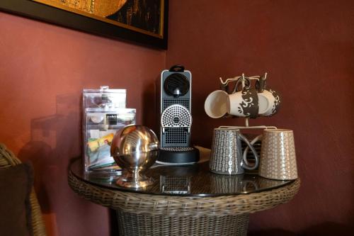 a table with a radio and other items on it at Le Moulin de Beaunette in Grane