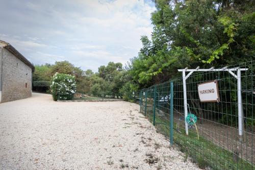 a fence with a sign that reads karma at Le Moulin de Beaunette in Grane