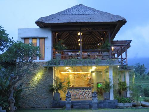 uma casa com um telhado que é iluminado em Sawah Indah Villa em Sidemen