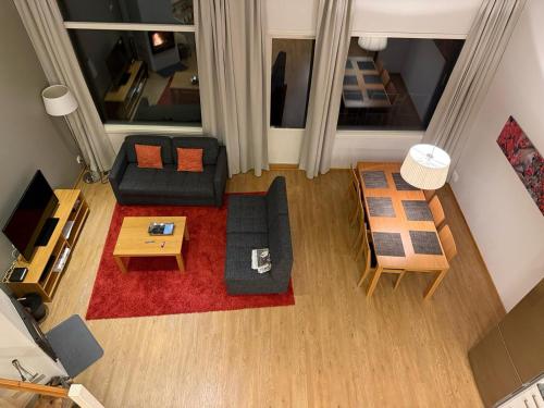 an overhead view of a living room with a couch and tables at Kylpyla SPA, Saimaa Villa 532 in Imatra