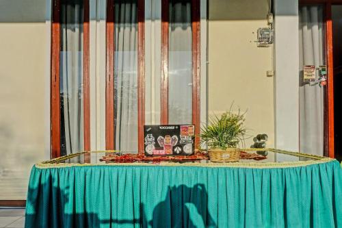 a table with a blue table cloth on top of it at Collection O 91488 Hotel Lingkarsut Jeneponto Near Patung kuda, Jeneponto in Pannara