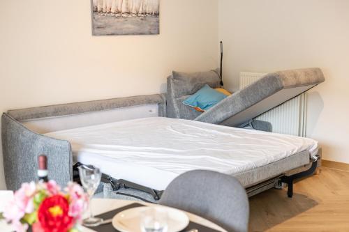 a bed in a room with a table and chairs at Walter Vilain 0105 in Sint-Idesbald