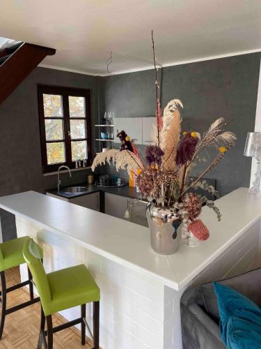 a kitchen with a counter with a vase of flowers on it at Neuss Zentrum 70qm Maisonette-Wohnung in Stadthaus in Neuss