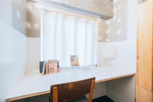 a desk with a chair in front of a window at Of Hotel in Sendai
