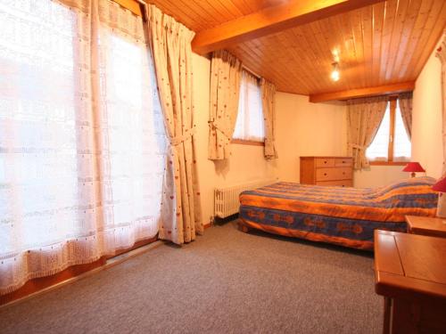 a bedroom with two beds and large windows at Châtel: Appt 4 pièces, 3 ch, 2 sdb, Wi-Fi, animaux admis, parking - FR-1-676-129 in Châtel