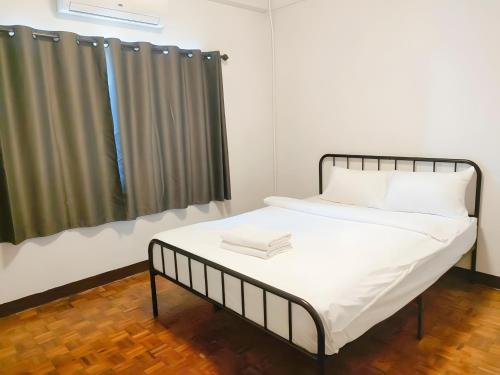 a small room with a bed and a window at xxStay On Maya - สเตย์ ออน เมญ่า เชียงใหม่ in Chiang Mai