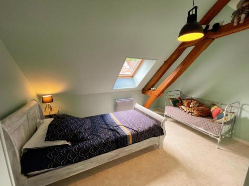 a bedroom with a bed and a window at Gîtes confortables près de Beauval avec wifi et parking - FR-1-491-457 in Meusnes