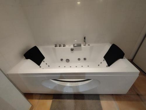 a white bath tub in a white room with at Charming comfortable barn in Coutras