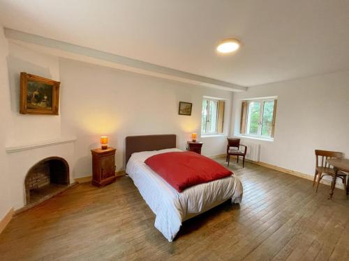 a bedroom with a bed and a fireplace at Le Moulin de Ronsard : Demeure spacieuse, jardin et vue sur le Loir - 8 personnes - FR-1-491-459 in Couture-sur-Loir
