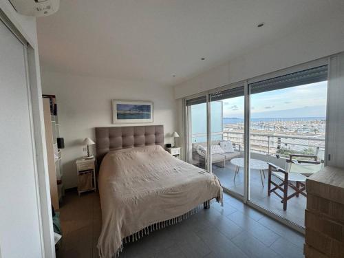 une chambre avec un lit et un balcon avec vue dans l'établissement Appartement 3 chambres avec piscine au centre-ville - FR-1-100-351, à Cavalaire-sur-Mer