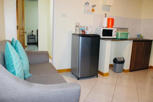 a living room with a couch and a microwave at Alona Austria Resort in Panglao