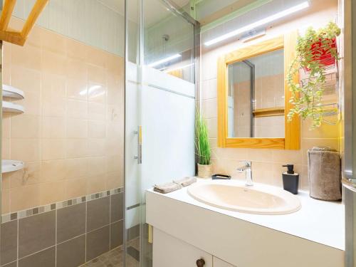 une salle de bain avec un lavabo et un miroir dans l'établissement Appartement calme près du centre Saint-Lary, 700m du téléphérique, 5 pers. max - FR-1-296-516, à Saint-Lary-Soulan