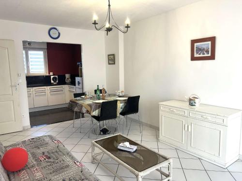 un salon avec une table et une cuisine dans l'établissement Appartement lumineux 2 pièces, terrasse au sud, parking privé à Fréjus - FR-1-226A-203, à Fréjus