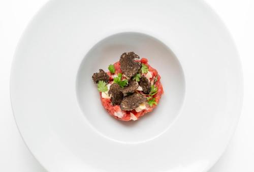 a bowl of food on a white plate at Bes Hotel Terme a Palazzago in Palazzago