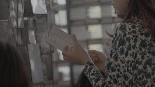 a woman is looking at a piece of paper at Private Chill Base たまて 三豊市荘内半島の古民家宿 一棟貸しも可 in Mitoyo