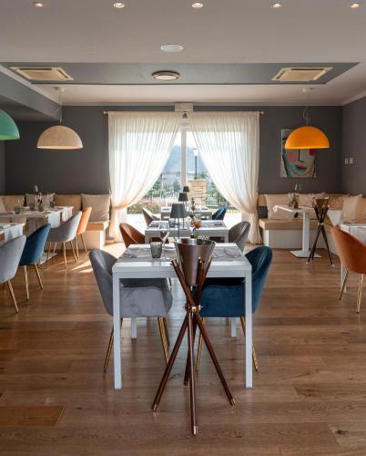 a restaurant with tables and chairs and a large window at Bes Hotel Terme a Palazzago in Palazzago