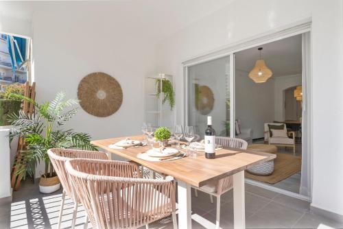 a dining room with a wooden table and chairs at Medina Garden 201 in Marbella