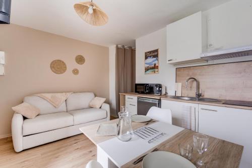 une cuisine et un salon avec un canapé et une table dans l'établissement Le Gabby, à Toulouse